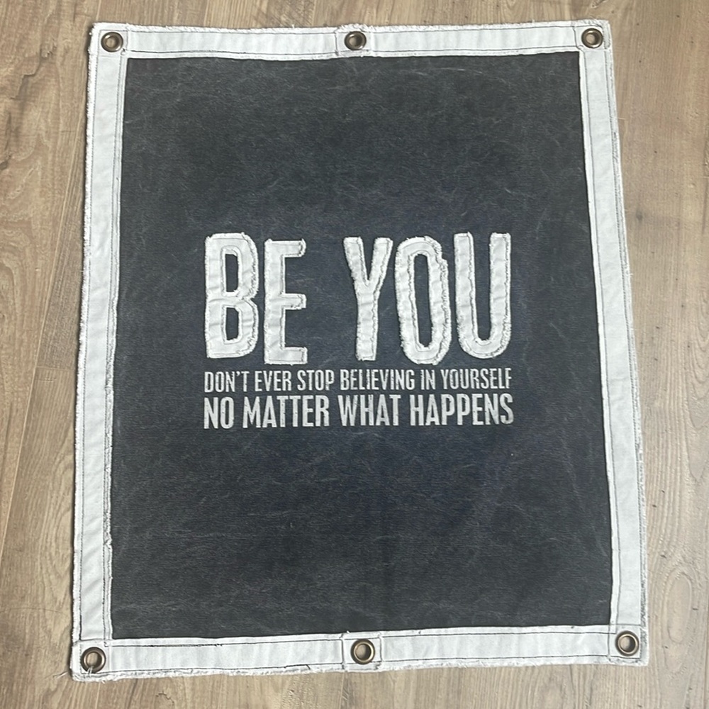 Super cute wall hanging with grommets.